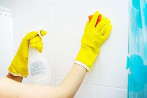 Cleaner vacuuming and mopping floors in a property